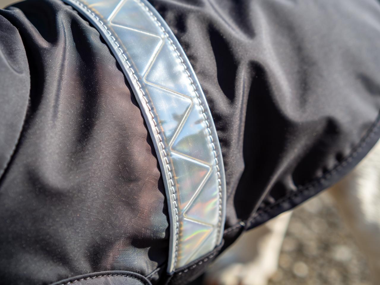 Close-up of Frenchie Vibe raincoat fabric and reflective trim.