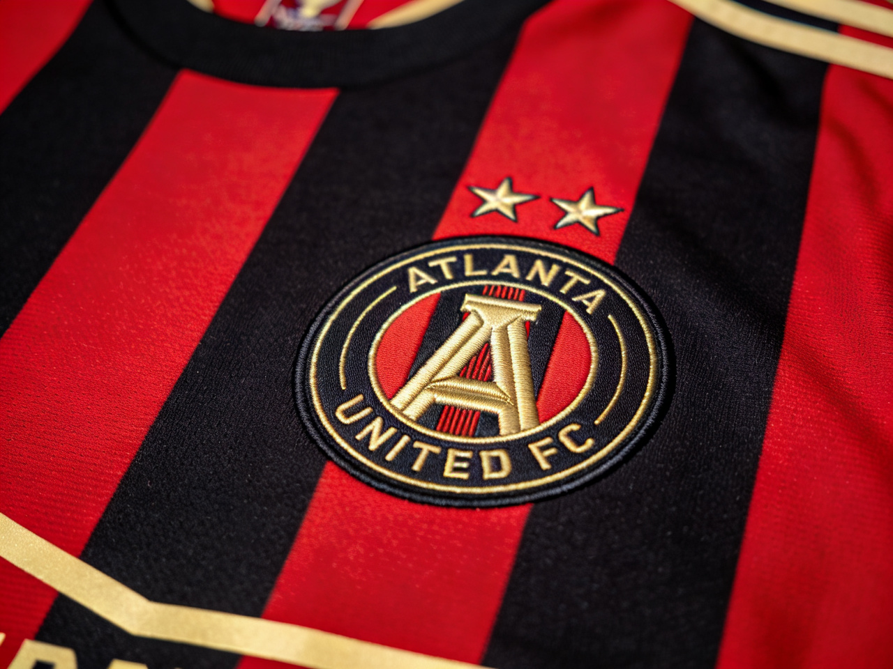 Detailed shot showcasing the five bold stripes and the MLS Cup star on the iconic Atlanta United home jersey.